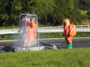 Firefighters from Thomastown and Graiguenamanagh wearing Gas tight suits whilst being decontaminated after dealing with a chemical incident near Belview Port